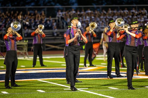 Ravenwood High band members march
